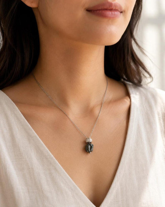 Model wearing raw hematite pendant necklace