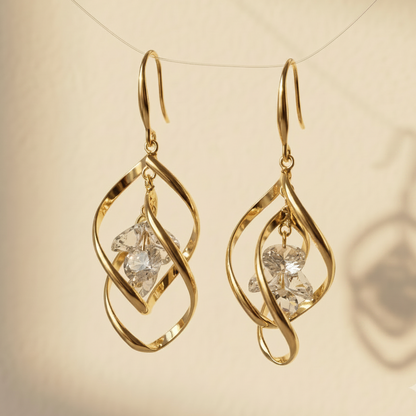 Gold earrings with diamond-like stones on a beige background