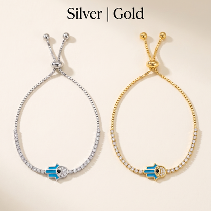 Two bracelets, one silver and one gold, with blue evil eye charms on a beige background.