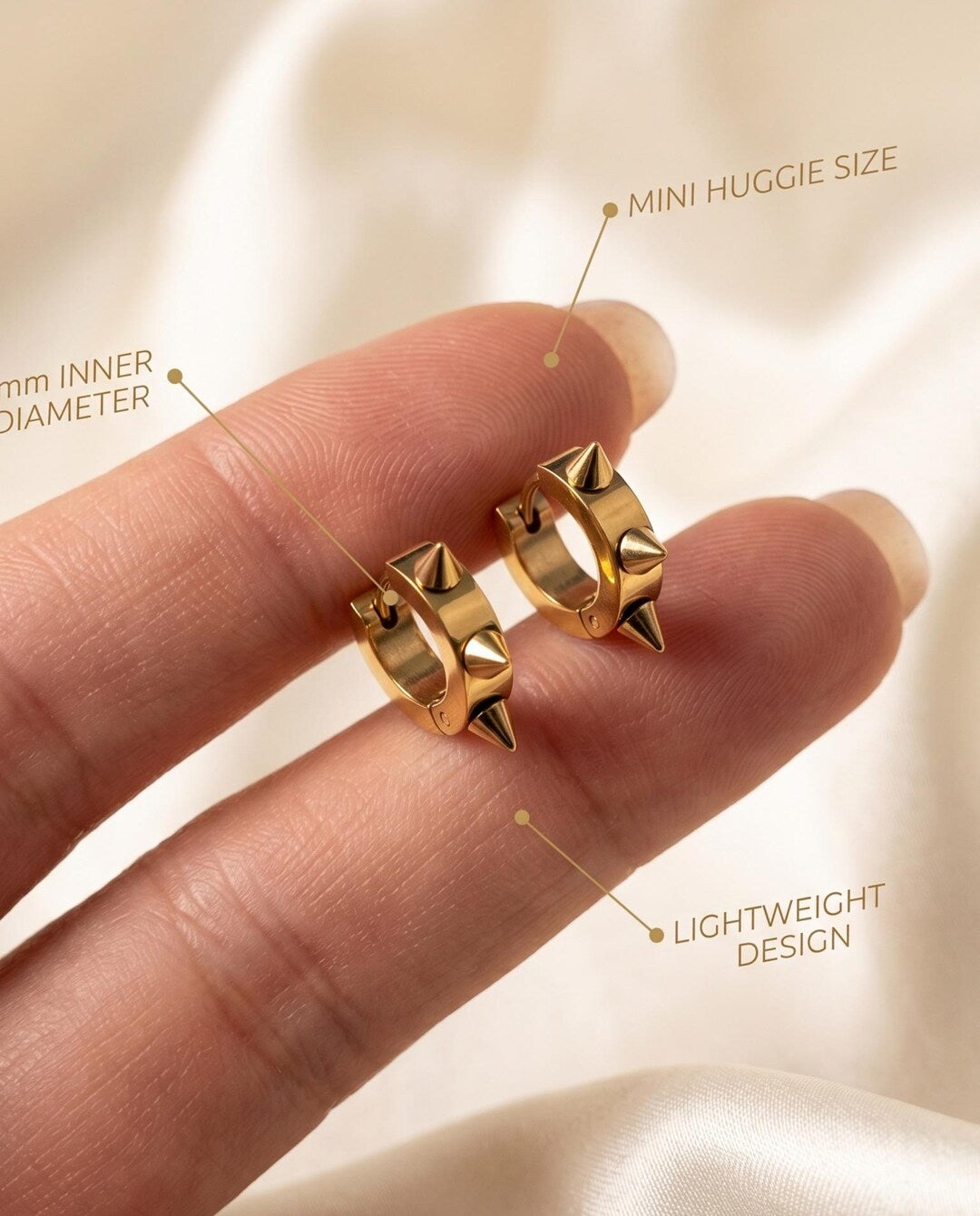 Side view of gold spiky huggie hoops showing hinged latch-back closure