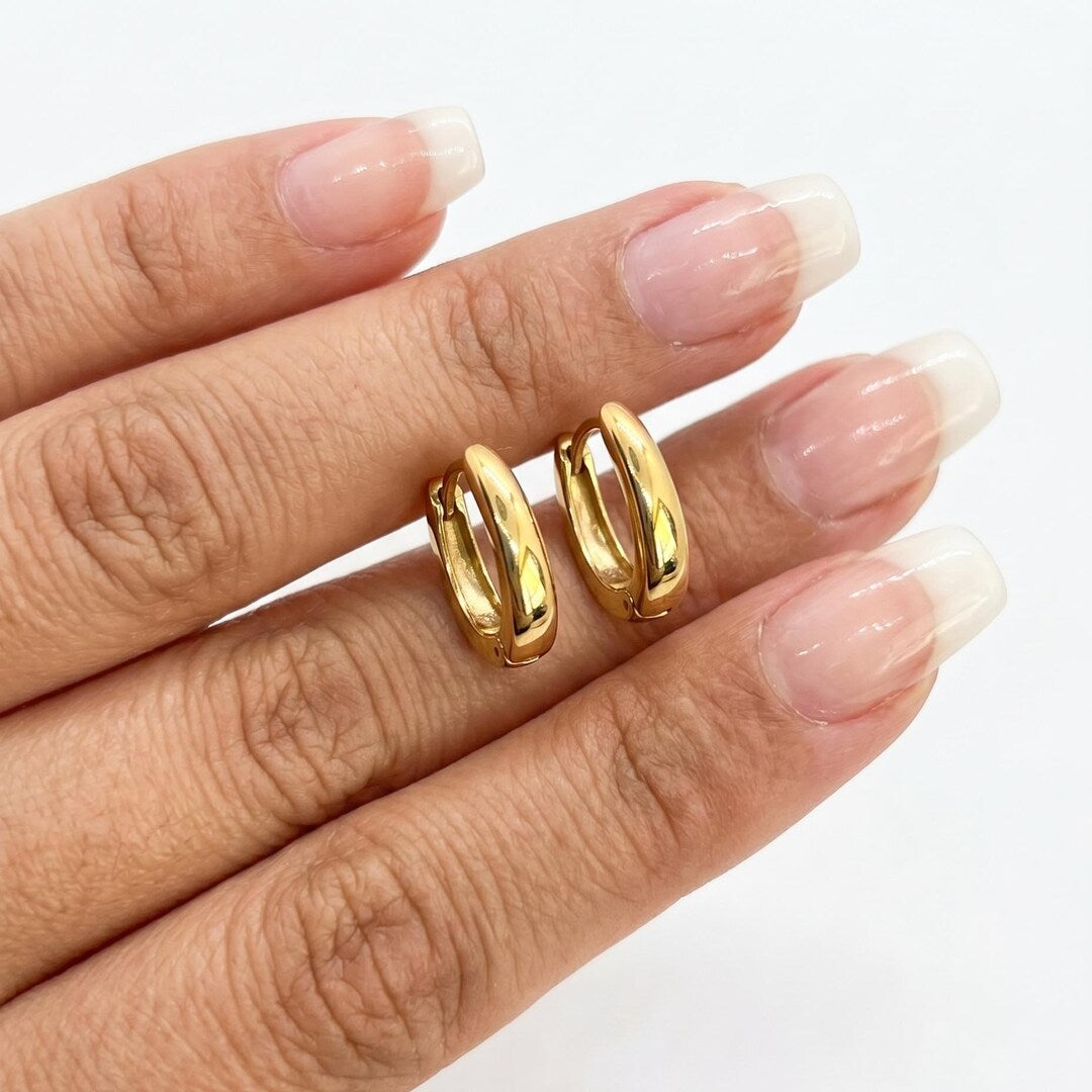 Gold huggie hoops lifestyle flat lay