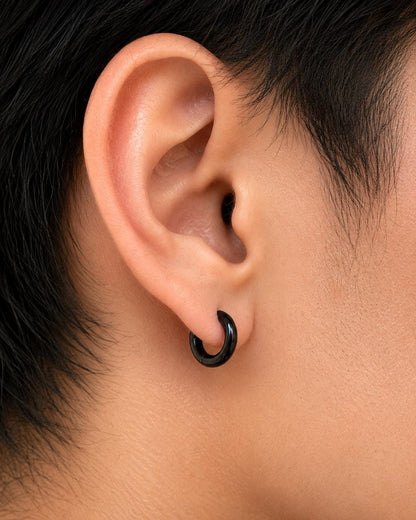 Black huggie hoops side profile showing 10mm size and secure hinged closure