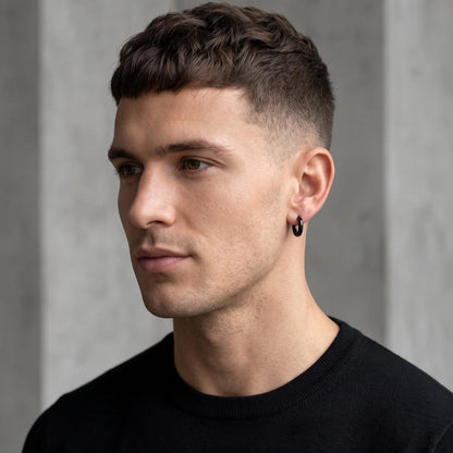 10mm black huggie hoops worn on ear — minimalist sleeper earrings
