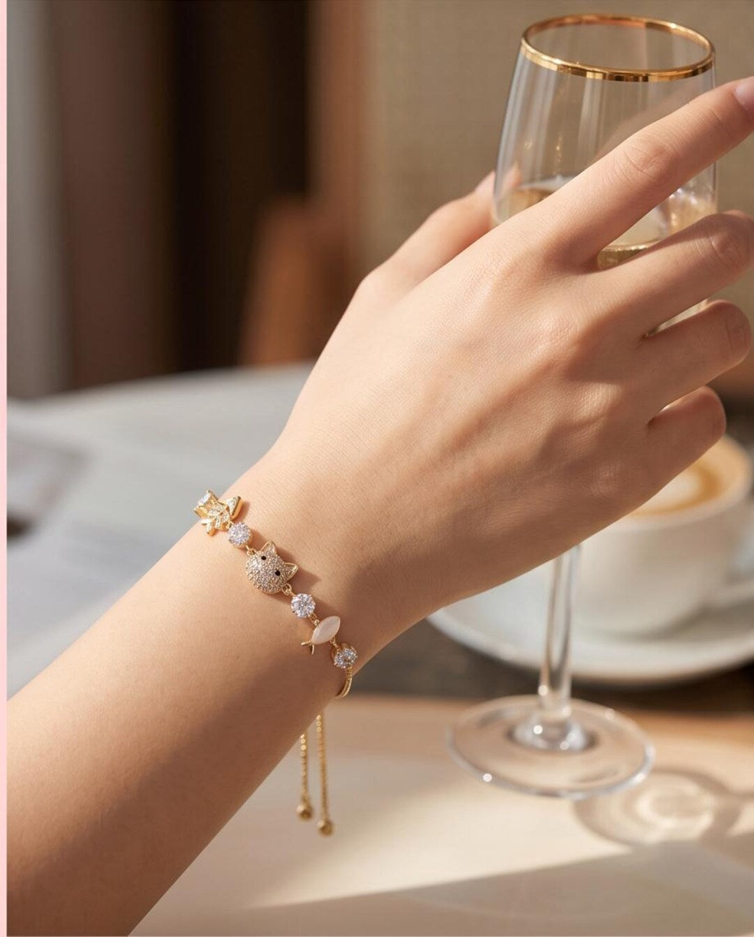 Gold kitty cat bracelet flat lay
