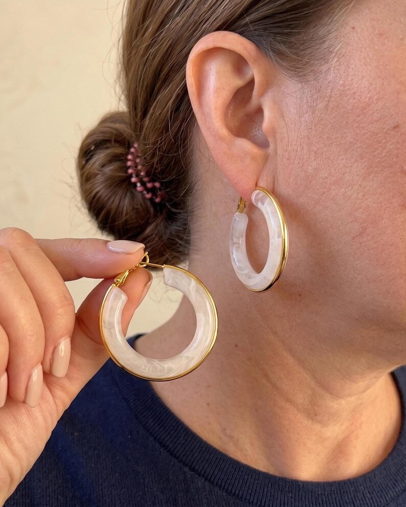 White and gold hoop earrings detail