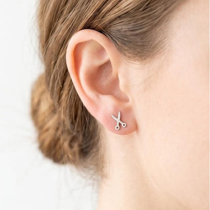 Scissors stud earrings worn by hairstylist
