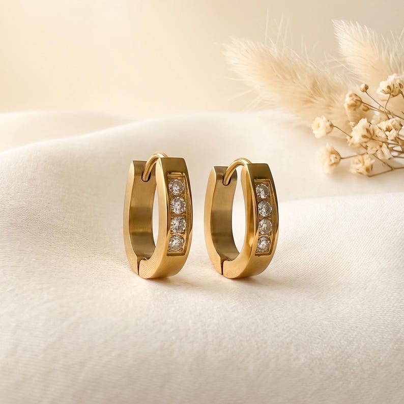 Gold horseshoe huggie hoop earrings close-up