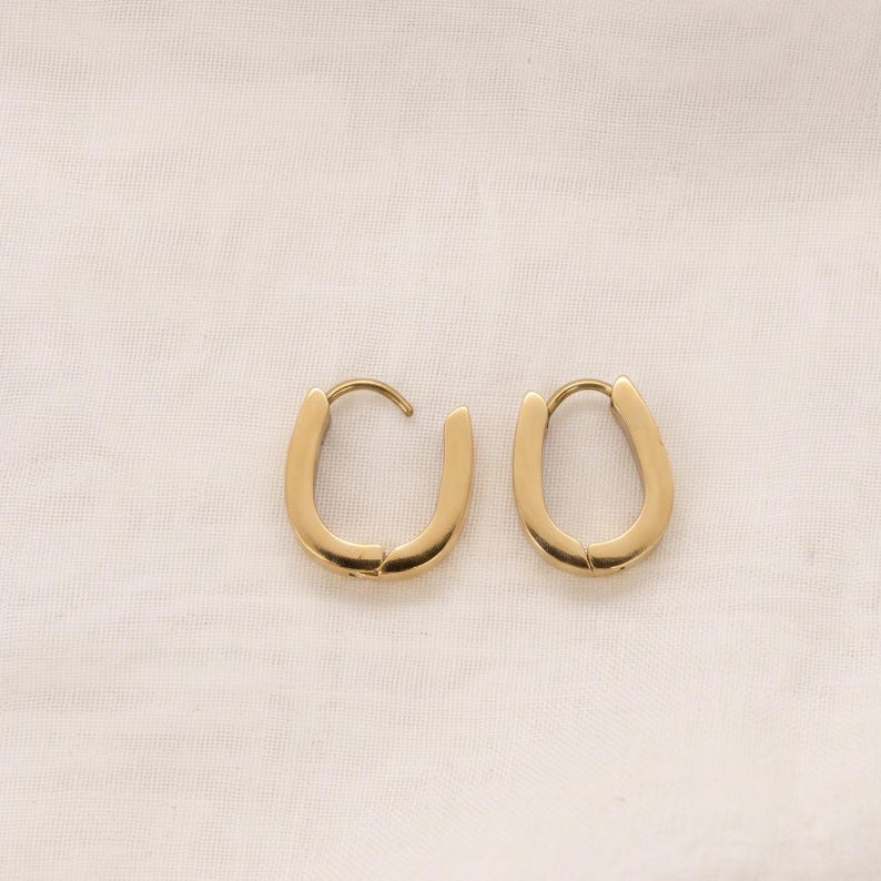 Gold horseshoe huggie hoop earrings final view