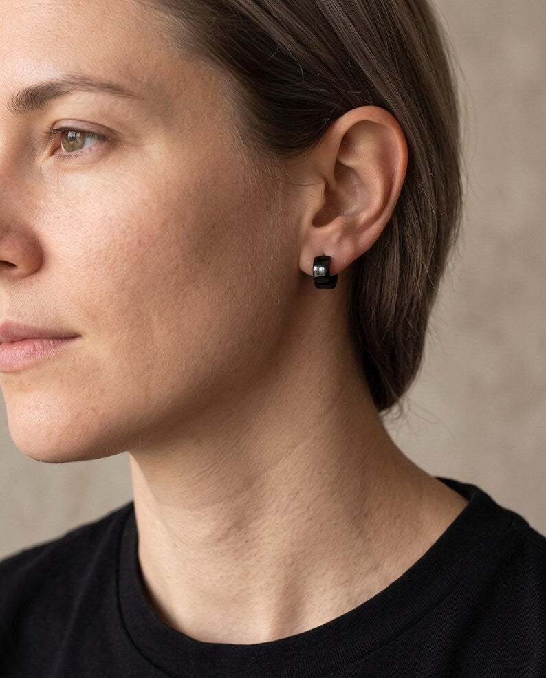 Black stainless steel huggie hoop earrings detail