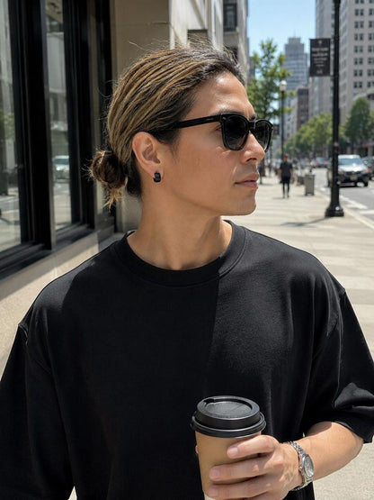 Black stainless steel huggie hoop earrings close-up