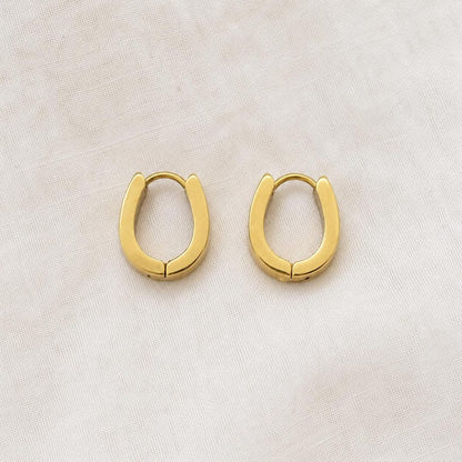 Gold horseshoe huggie hoop earrings close view