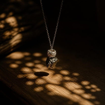 Raw hematite pendant necklace on wood surface