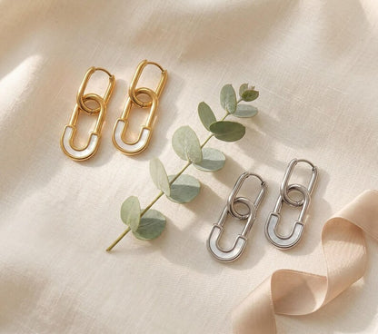 Gold and silver safety pin huggie hoop earrings with eucalyptus
