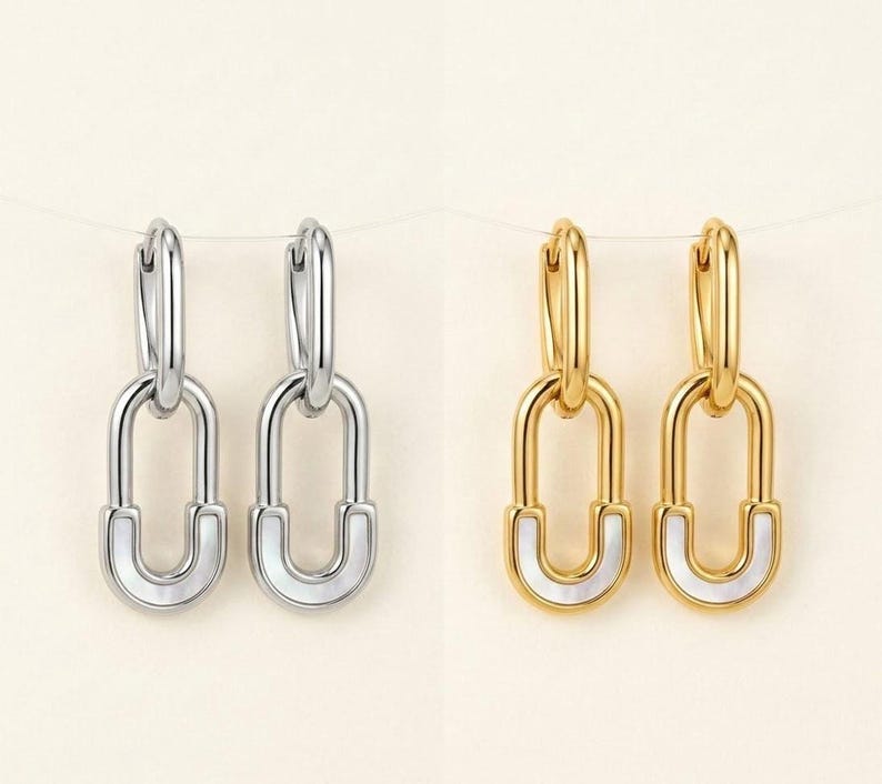 Silver and gold safety pin huggie hoop earrings side by side