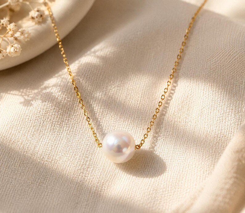 Pearl necklace close up on fabric with dried flowers