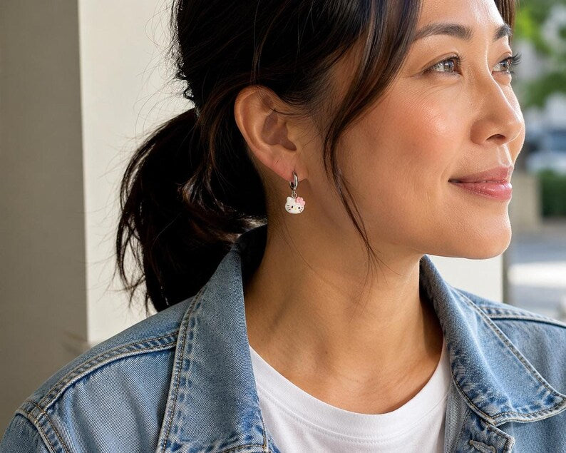 Model in denim jacket wearing kitty charm earring