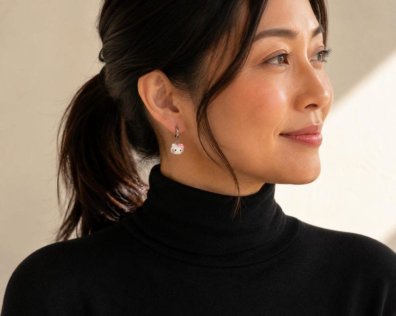 Model in black turtleneck wearing kitty charm earring