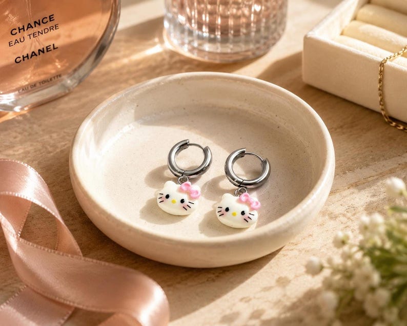 Kitty charm huggie hoop earrings in ceramic dish