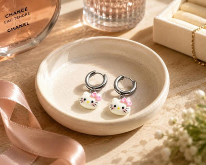 Kitty charm huggie hoop earrings in ceramic dish