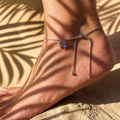 Close up of anklet under palm leaf shadows