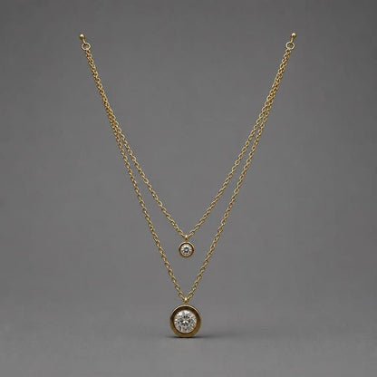 Layered gold CZ necklace on gray background