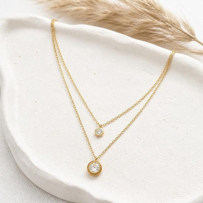 Layered gold CZ necklace on ceramic dish