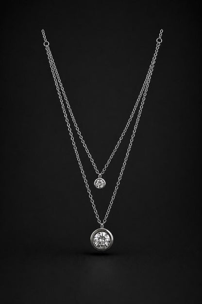 Layered silver CZ necklace on black background