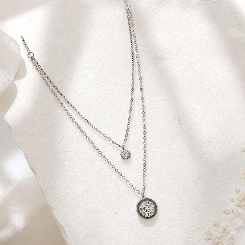 Layered silver CZ necklace on white background
