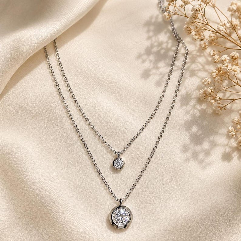 Layered silver CZ necklace on satin fabric