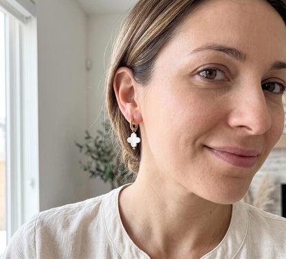 Model smiling wearing Mother of Pearl clover earring