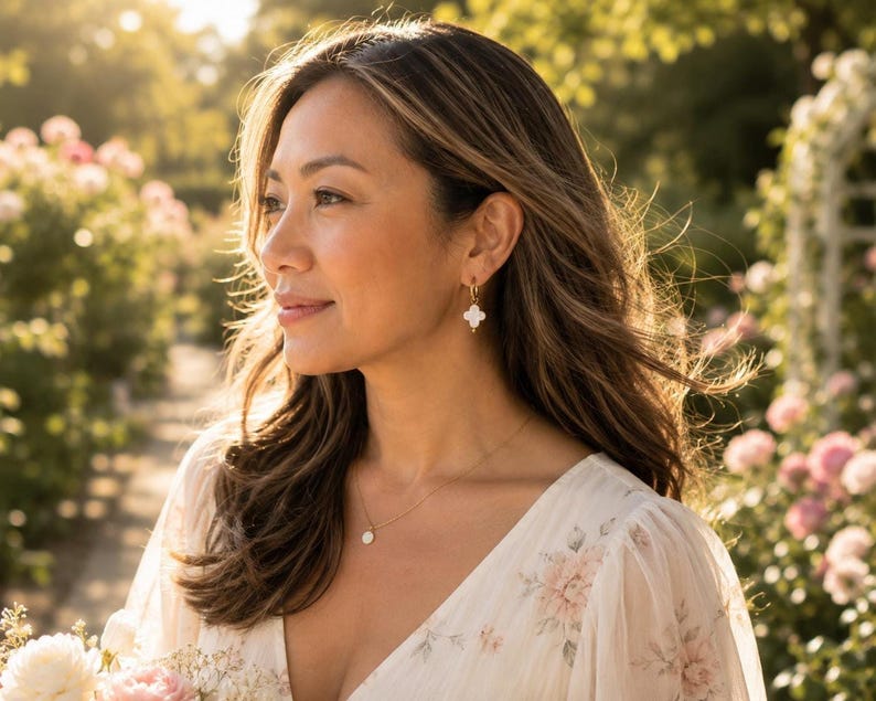 Model wearing Mother of Pearl clover earring outdoors