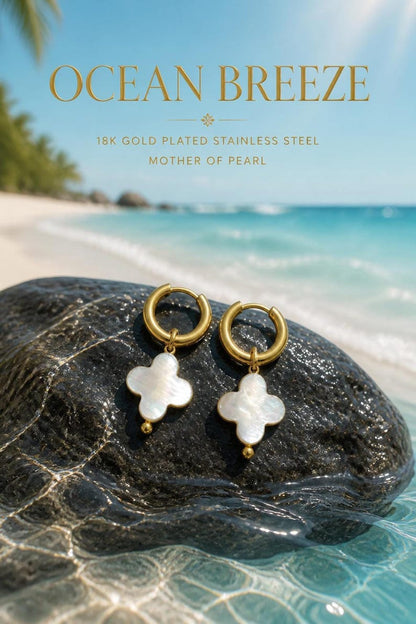 Mother of Pearl clover earrings on beach rock