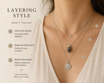 Model wearing raw hematite necklace layered with other necklaces