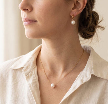 Model wearing freshwater pearl necklace and earrings