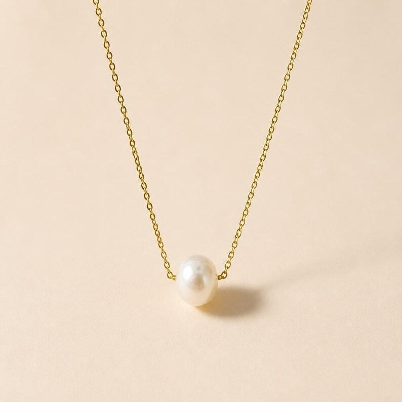 Gold chain necklace with single pearl pendant