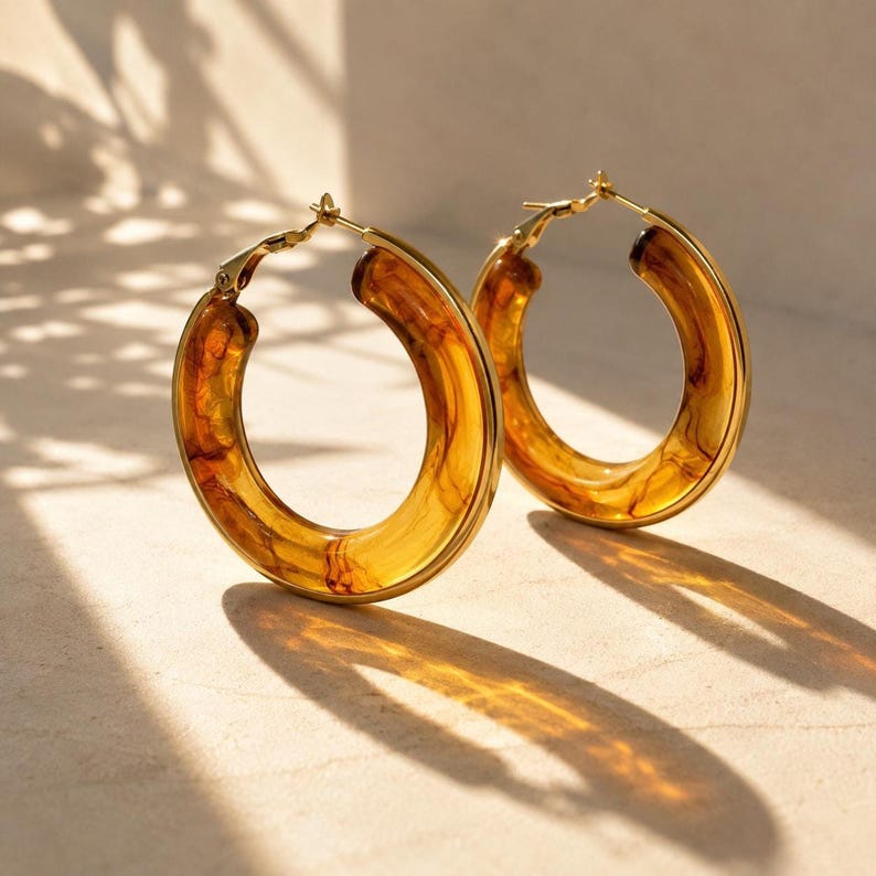 Amber tortoiseshell resin hoop earrings with gold-plated edges