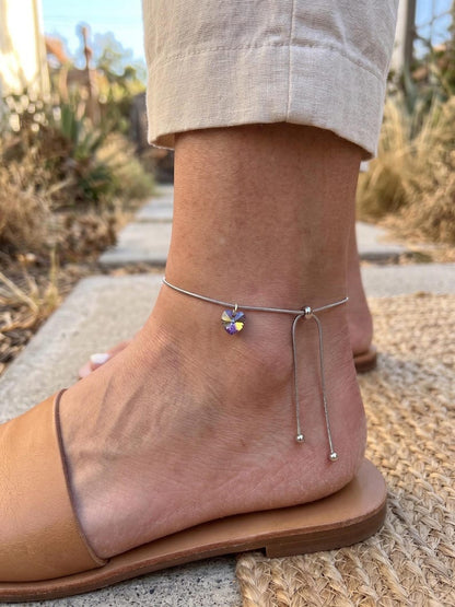 Close up of crystal heart charm on anklet