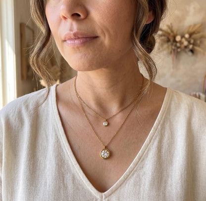 Model wearing layered gold CZ necklace