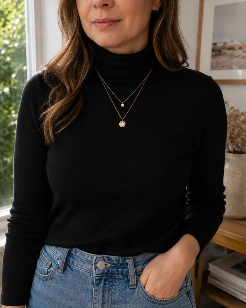 Model wearing layered gold CZ necklace with turtleneck