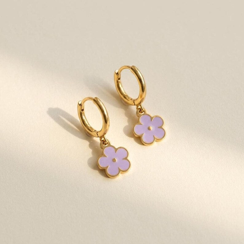 Gold hoop earrings with light purple floral charms