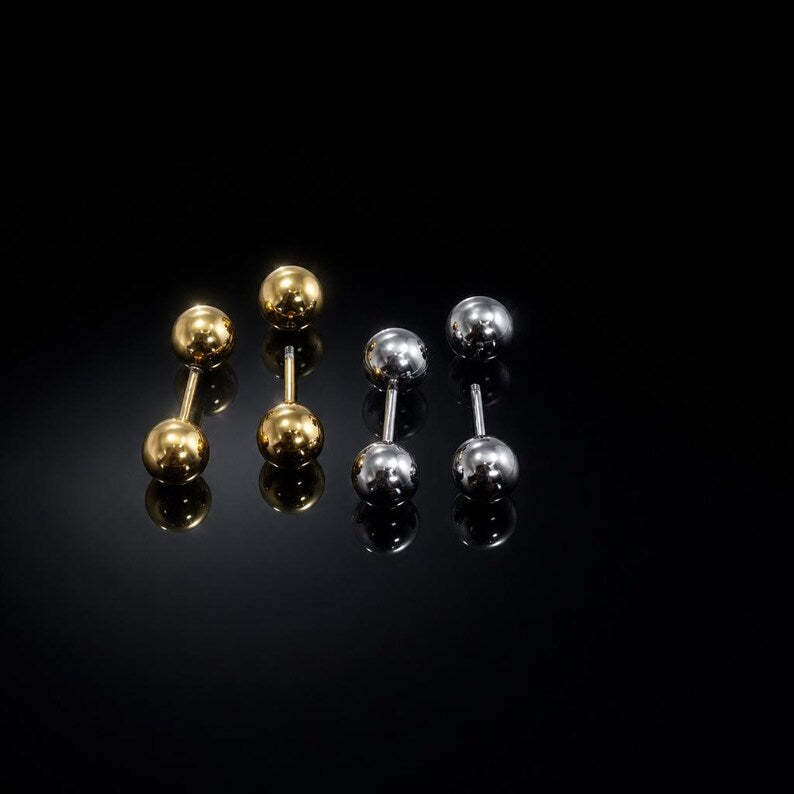 Ball stud earrings on neutral background
