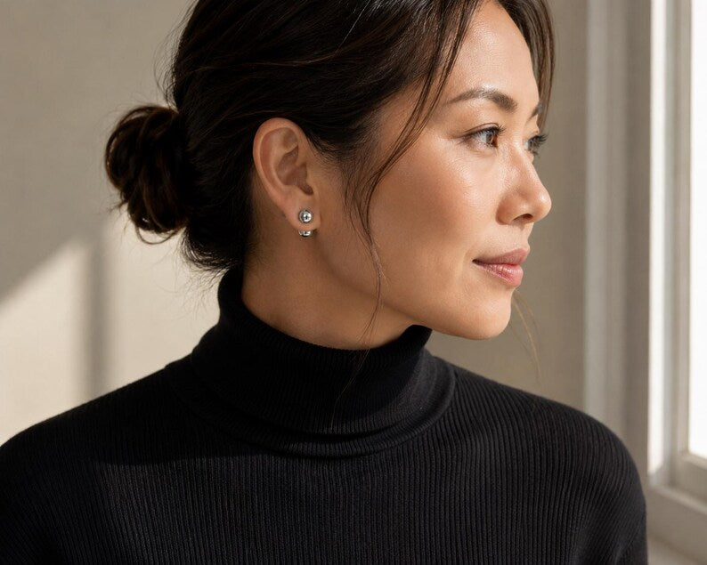Ball stud earrings worn with hair tucked back