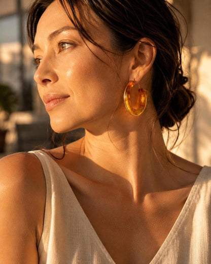 Sunlit profile view wearing tortoiseshell resin hoops