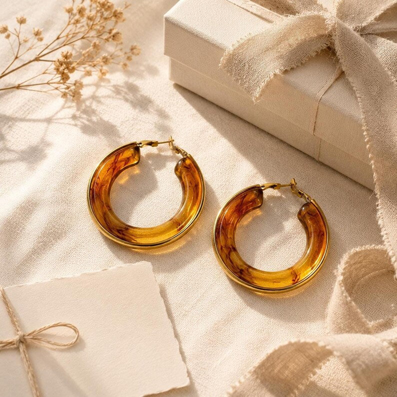 Earrings displayed with gift box and dried flowers