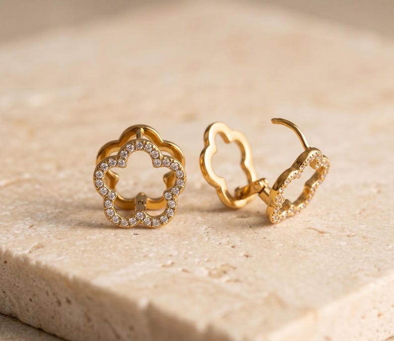 Gold flower hoop earrings showing clasp mechanism