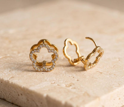 Gold flower hoop earrings showing clasp mechanism