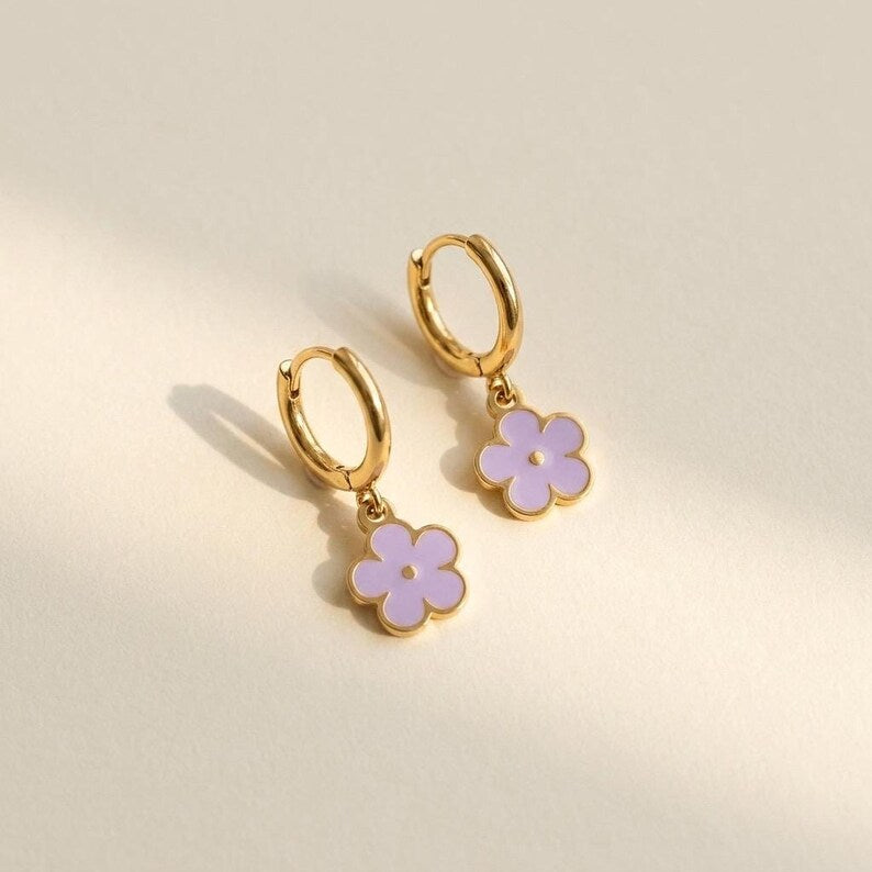 Gold hoop earrings with dangling purple enamel daisy charms
