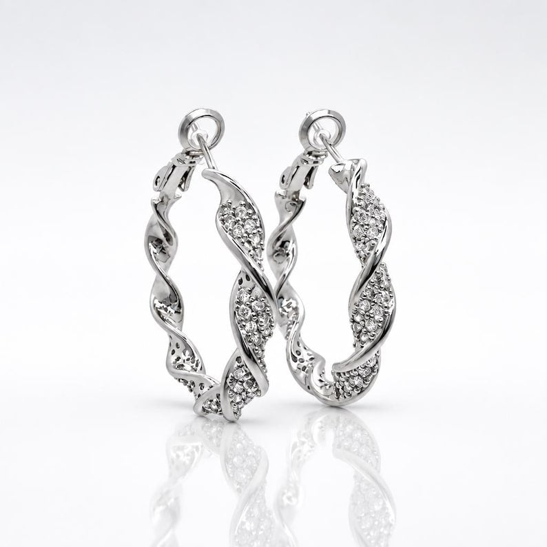 Close-up of twisted crystal pave hoop earring