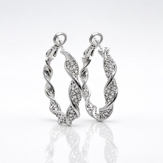 Close-up of twisted crystal pave hoop earring