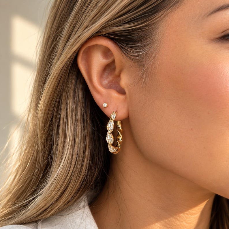 Twisted crystal pave hoop earrings on display